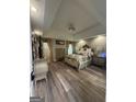 Spacious main bedroom with tray ceilings, hardwood floors, and coordinated furniture set at 25 Castlehill Ct, Covington, GA 30016