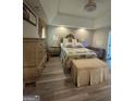 Cozy main bedroom with elegant decor, soft lighting, and a plush upholstered bench at 25 Castlehill Ct, Covington, GA 30016