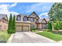 Beautiful two-story brick home featuring a two-car garage, lush landscaping, and a welcoming front entrance at 4924 Locklear Way, Marietta, GA 30066