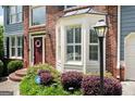 Close up showcasing a brick facade, bay window, and lush landscaping, creating a welcoming and picturesque curb appeal at 5418 Amity Dr, Powder Springs, GA 30127