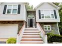 Close-up of the front door with white stairs and railings, complemented by stone accents at 7030 Wessex Way, Cumming, GA 30028