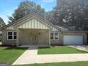 Inviting brick home with a covered porch and well-maintained lawn enhancing its curb appeal at 243 Roxbury Dr, Riverdale, GA 30274