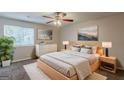 Comfortable main bedroom with a ceiling fan, natural light, and neutral decor at 6200 Beaver Creek Trl, Atlanta, GA 30349