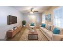 Bright living room features a cozy sofa, armchair, stylish decor, and natural light from large windows at 1105 Buckhurst Dr, Atlanta, GA 30349
