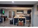 Open kitchen design with island, dark blue cabinets, granite countertops, and stainless steel appliances at 176 Avalon Way, Riverdale, GA 30274