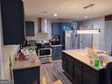 Modern kitchen featuring stainless steel appliances, granite countertops, and ample cabinet space at 176 Avalon Way, Riverdale, GA 30274
