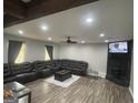 Spacious living room featuring a large sectional couch and modern flooring at 176 Avalon Way, Riverdale, GA 30274