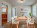 Bright dining room featuring a table set for six and view to kitchen at 2245 Dauphine St, Atlanta, GA 30344