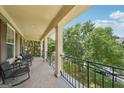 Relaxing balcony featuring seating, a black metal railing, and neighborhood views for enjoying the outdoors at 826 Richmond Cir, Peachtree City, GA 30269