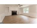 Spacious living room with hardwood floors, built-in cabinets, and a cozy fireplace at 5674 Mountain Cres, Stone Mountain, GA 30087