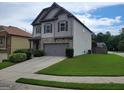 Beautiful home with well-maintained lawn, a two-car garage, and gray exterior at 2424 Saint Andrews Rdg, College Park, GA 30337