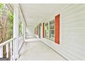 Spacious front porch with classic white columns and bright red window shutters at 936 Bo Bo Banks Rd, Grantville, GA 30220