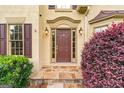 Charming front door entrance framed with decorative plants and stone pathway at 2864 Wyndcliff Ct, Marietta, GA 30066