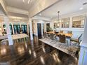 Elegant dining room with dark hardwood floors, designer rug, and modern chandelier at 4564 Investors Ln, Ellenwood, GA 30294