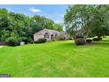 Well-maintained brick home set on a large lot with mature trees and landscaping at 186 Ashley Dr, Mcdonough, GA 30252
