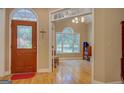 Inviting entryway with hardwood floors and views into the living room with large window at 1041 Flat Rock Rd, Covington, GA 30014