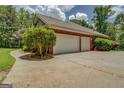 Detached two-car garage with a large driveway, offering ample parking space at 1041 Flat Rock Rd, Covington, GA 30014
