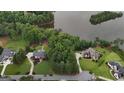 Aerial view showcasing the natural beauty of the real estate, lake, and lush green landscape at 81 Smokerise Pt, Peachtree City, GA 30269