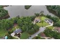 Aerial view of a luxurious lakeside community surrounded by lush trees and serene lake waters at 81 Smokerise Pt, Peachtree City, GA 30269