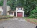 Charming home featuring a one-car garage, with neutral siding and red trim at 101 Pinetree Trl, Atlanta, GA 30349