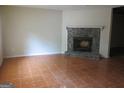 Cozy living room featuring a classic stone fireplace and tile flooring, perfect for relaxation at 101 Pinetree Trl, Atlanta, GA 30349