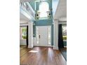 Inviting foyer with a high ceiling, hardwood floors, and a view of the upper level at 1209 Polk Xing, Mcdonough, GA 30252