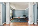 Home gym with rubber floor, bench, weights, blue walls, and hardwood floor at 1209 Polk Xing, Mcdonough, GA 30252