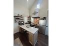 Modern kitchen with stainless steel appliances, a central island with bar seating, and stylish floating shelves at 155 Central Ave, Fayetteville, GA 30214
