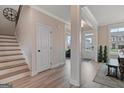 Bright entryway with hardwood floors, staircase, and ample natural light from nearby windows at 313 Westfall Ter # 225A, Loganville, GA 30052