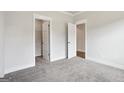 Neutral bedroom with plush carpet and access to closets and ensuite bathroom through white doors at 605 Somerset Ct # 161A, Loganville, GA 30052