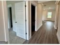 Bright hallway featuring sleek wood flooring, white trim, and access to various rooms at 504 Clayborne Way # 248A, Loganville, GA 30052