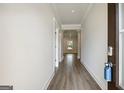 Hallway featuring sleek wood flooring and white walls, leading into open living spaces at 504 Clayborne Way # 248A, Loganville, GA 30052