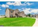 Spacious home featuring a lush green lawn and classic brick elevation at 209 Osier Dr, Mcdonough, GA 30252
