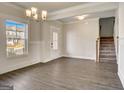 Open-concept living room features hardwood floors, wainscoting, and ample natural light at 714 Bristol Dr # 279A, Loganville, GA 30052
