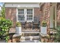 Close-up of a cozy front porch with rocking chairs and potted flowers at 1718 Ridgewood Ne Dr, Atlanta, GA 30307