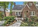 Inviting brick home with a cozy front porch and meticulous landscaping at 1718 Ridgewood Ne Dr, Atlanta, GA 30307