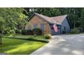 Home with brick and siding exterior, showcasing a well-maintained lawn and driveway at 4710 Cedar Brook Se Dr, Conyers, GA 30094
