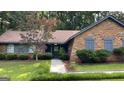 Home exterior showcasing a brick facade, tidy landscaping, and inviting walkway leading to the front entrance at 4710 Cedar Brook Se Dr, Conyers, GA 30094