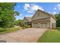 Landscaped home with a 2-car garage, long driveway and large lawn at 9360 Ward Rd, Winston, GA 30187