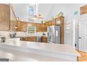 Kitchen with wood cabinets, stainless steel appliances, and white countertop at 116 Alexander Dr, Mcdonough, GA 30252