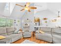 Open living room with vaulted ceilings, wood floors, and an open floor plan to the kitchen at 116 Alexander Dr, Mcdonough, GA 30252
