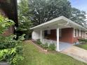 The home has a back entrance with a covered patio and landscaped area at 24 Mobley Se Dr, Atlanta, GA 30315