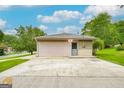 The home has a detached garage with a door and a separate entrance, with a large area for additional parking at 741 Greenhill Ne Dr, Conyers, GA 30012