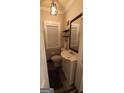 Cozy bathroom featuring a vanity with white cabinets, a window, and a framed mirror at 1270 M L King Jr Sw Dr, Atlanta, GA 30314