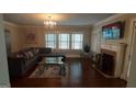 Bright living room featuring hardwood floors, a fireplace, and a large sectional sofa at 1270 M L King Jr Sw Dr, Atlanta, GA 30314