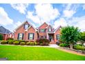 Charming brick home with meticulous landscaping under a bright sky at 713 Birkdale Blvd, Carrollton, GA 30116