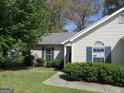 Charming single-story home with manicured lawn and neat landscaping, enhancing its curb appeal at 5799 Eagles Feather Ln, Riverdale, GA 30274