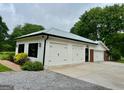 Spacious three car garage with white doors and modern black trim at 360 Morgan Mill Rd, Brooks, GA 30205