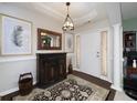 Welcoming foyer with hardwood floors, stylish rug, decorative mirror, and ample natural light at 245 Edenwylde Ct, Hampton, GA 30228