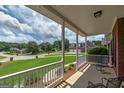 Relax on this covered porch, enjoying views of the expansive front yard and quiet neighborhood at 245 Edenwylde Ct, Hampton, GA 30228